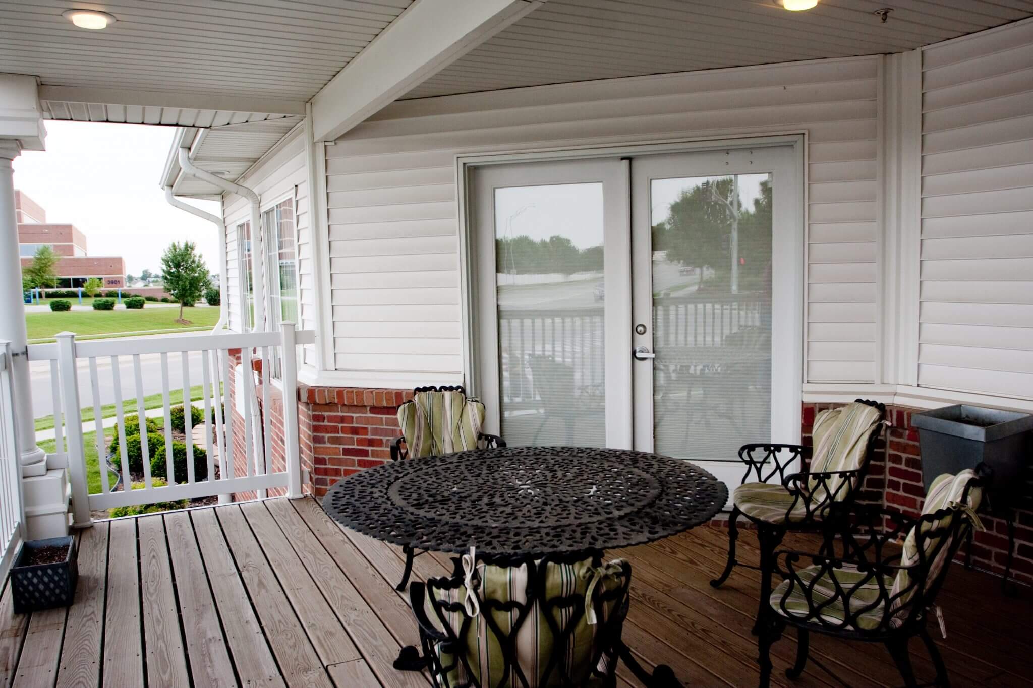 wooden porch with table and chairs