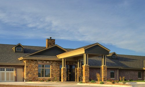 The Waterford Wilderness Hills Memory Care Facility exterior at sunset