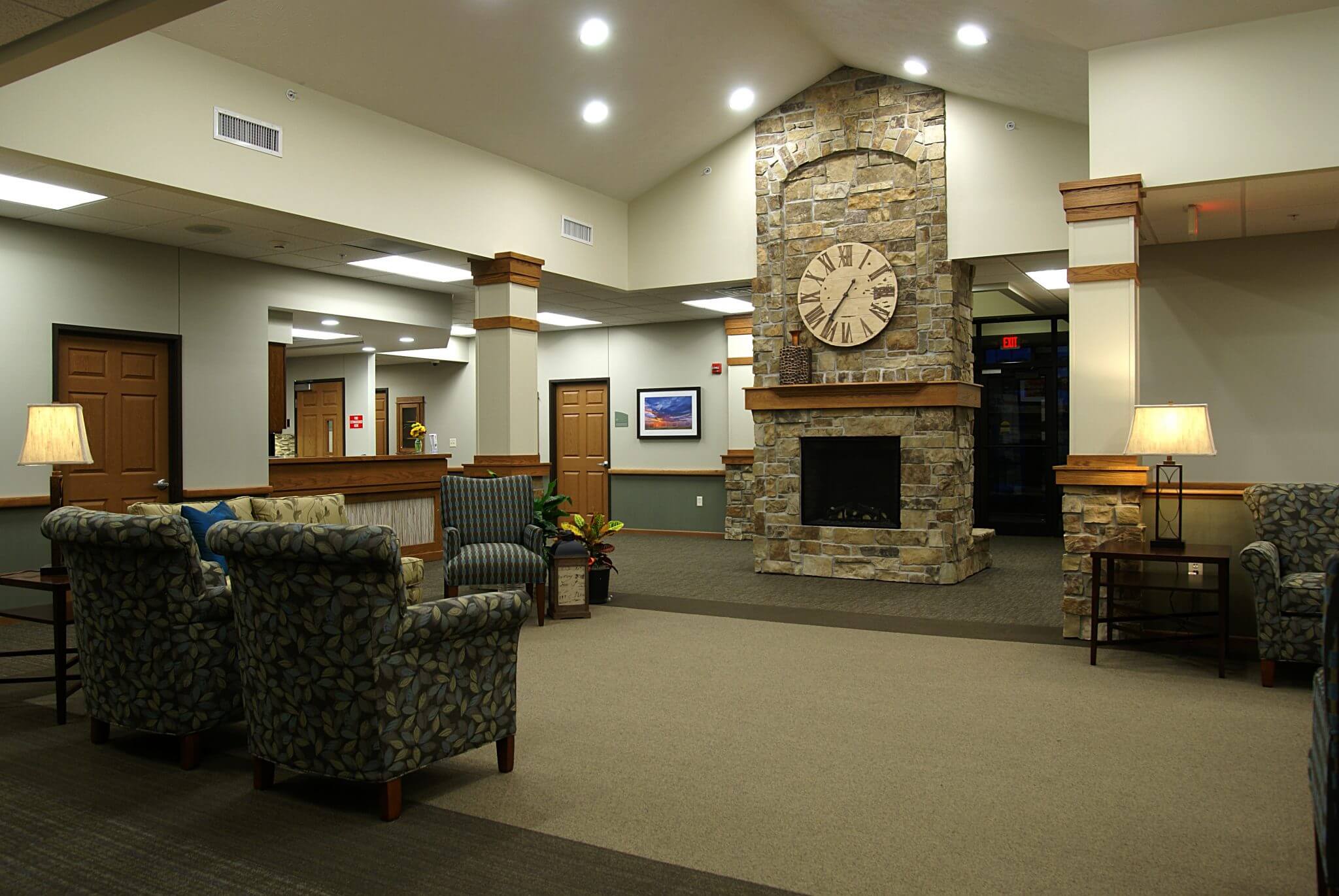 interior shot of waterford entry with fireplace, seating area, and welcome desk