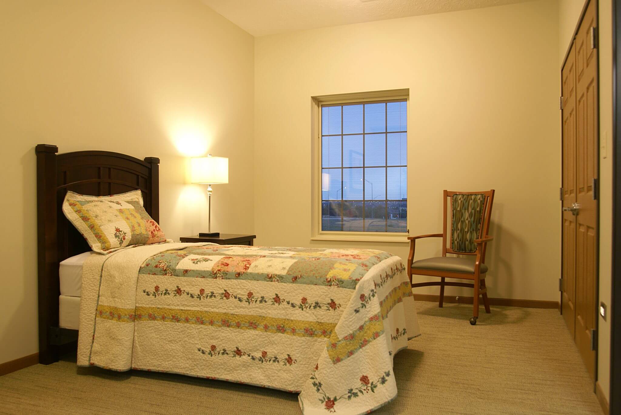 interior shot of bedroom with quilt on bed