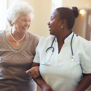 elderly woman walking with caretaker