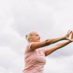 Senior Fitness being practiced outside by an elderly woman.