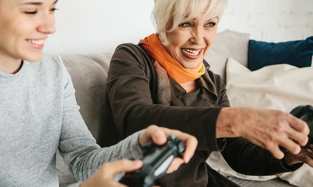 a senior woman and her grand-daughter gaming