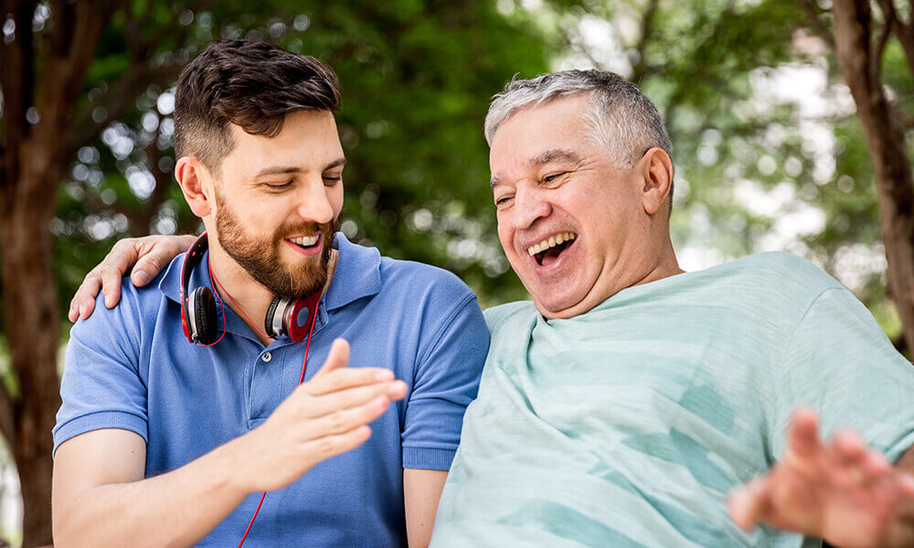 young male student laughing with senior living partner